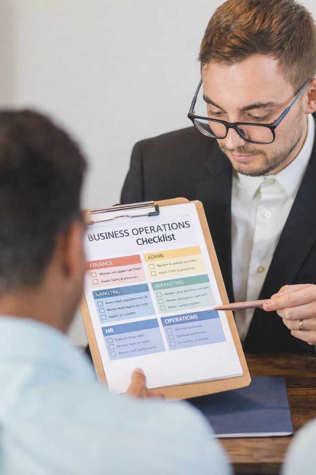 Colleagues discussing checklist